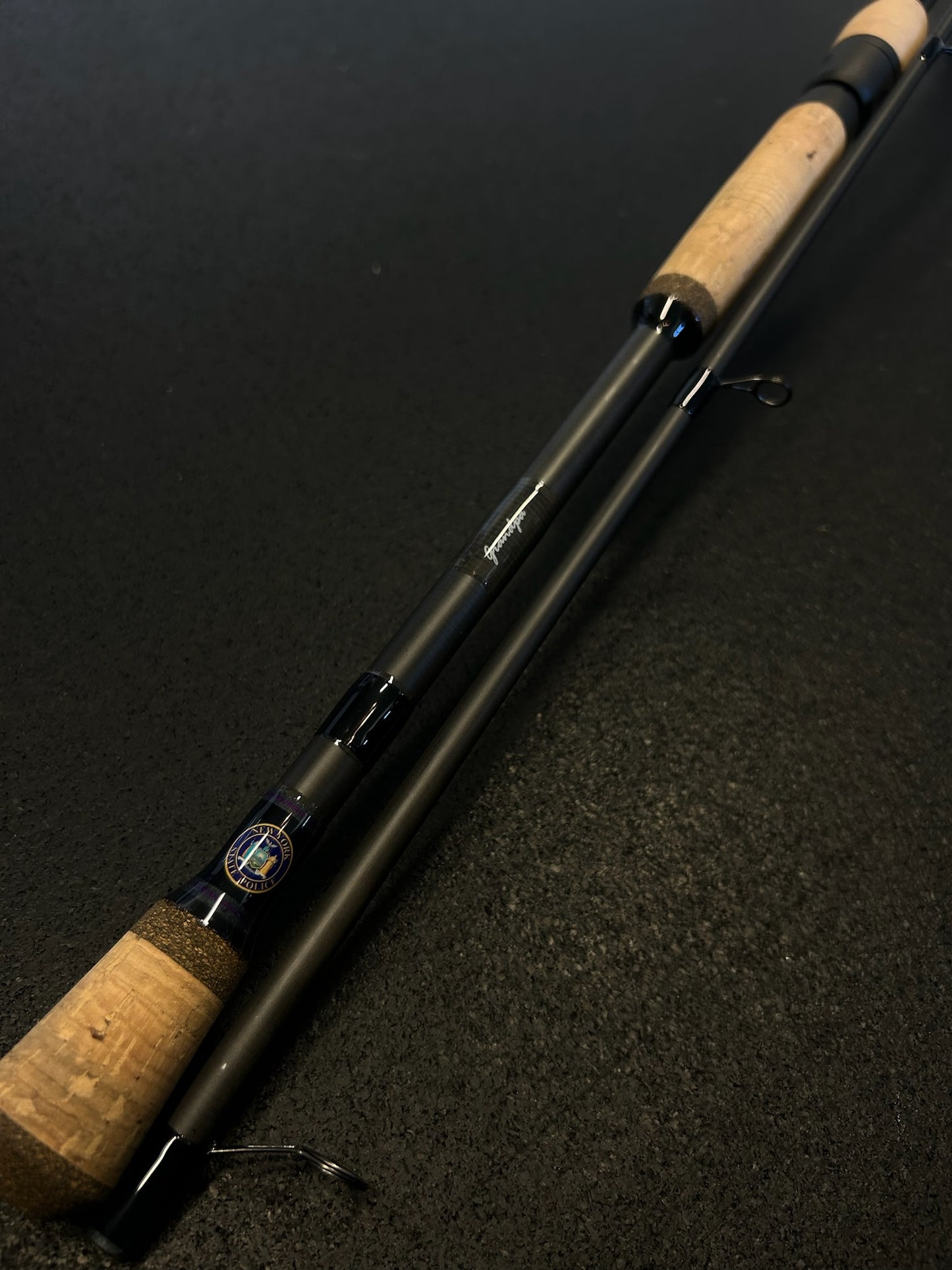 Two piece spinning rod with police logo and badge number